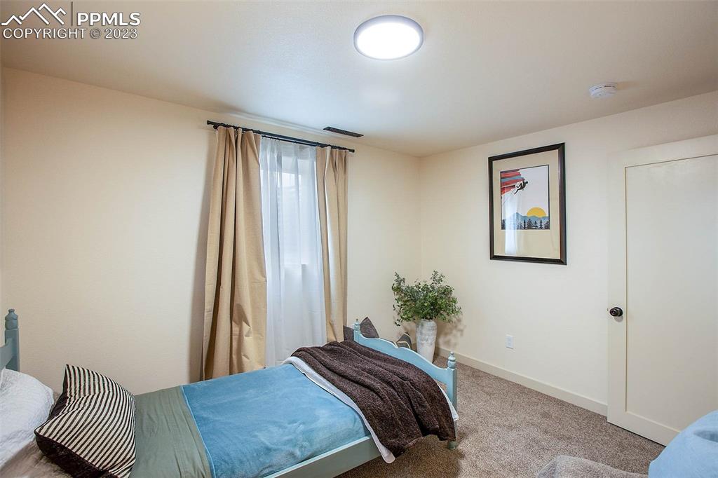 2415 Monterey Road Colorado Springs, CO 80910 - Photo 27 of 36 a bedroom with a bed and a window