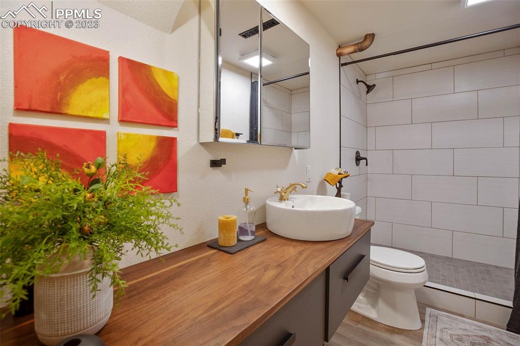2415 Monterey Road Colorado Springs, CO 80910 - Photo 28 of 36 a bathroom with a sink toilet and shower