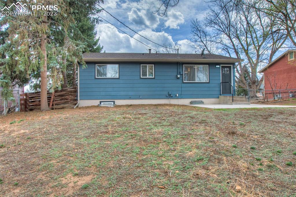 2415 Monterey Road Colorado Springs, CO 80910 - Photo 32 of 36 a front view of a house with a garden
