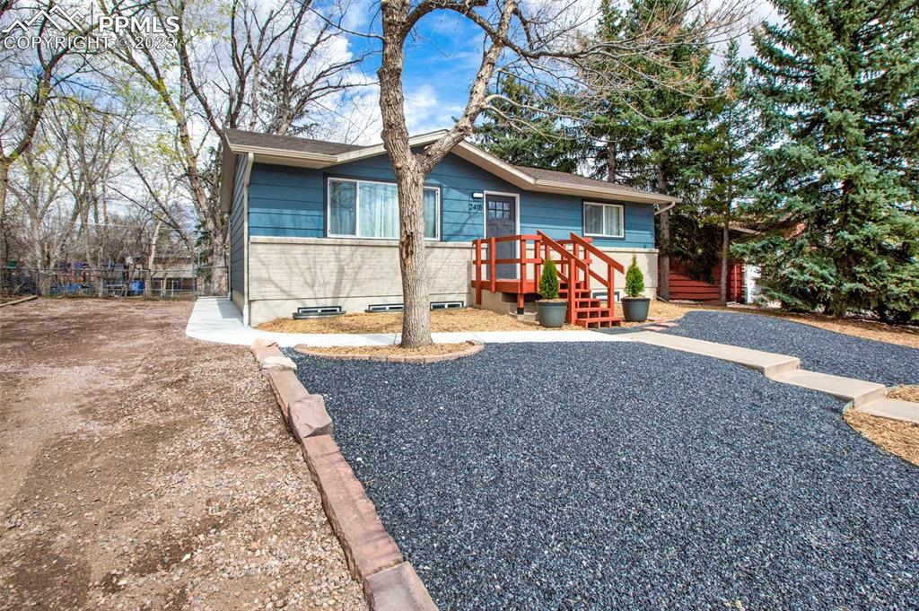 2415 Monterey Road Colorado Springs, CO 80910 - Photo 36 of 36 a view of a house with backyard and a tree