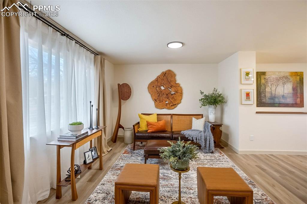 2415 Monterey Road Colorado Springs, CO 80910 - Photo 7 of 36 a living room with furniture and a wooden floor