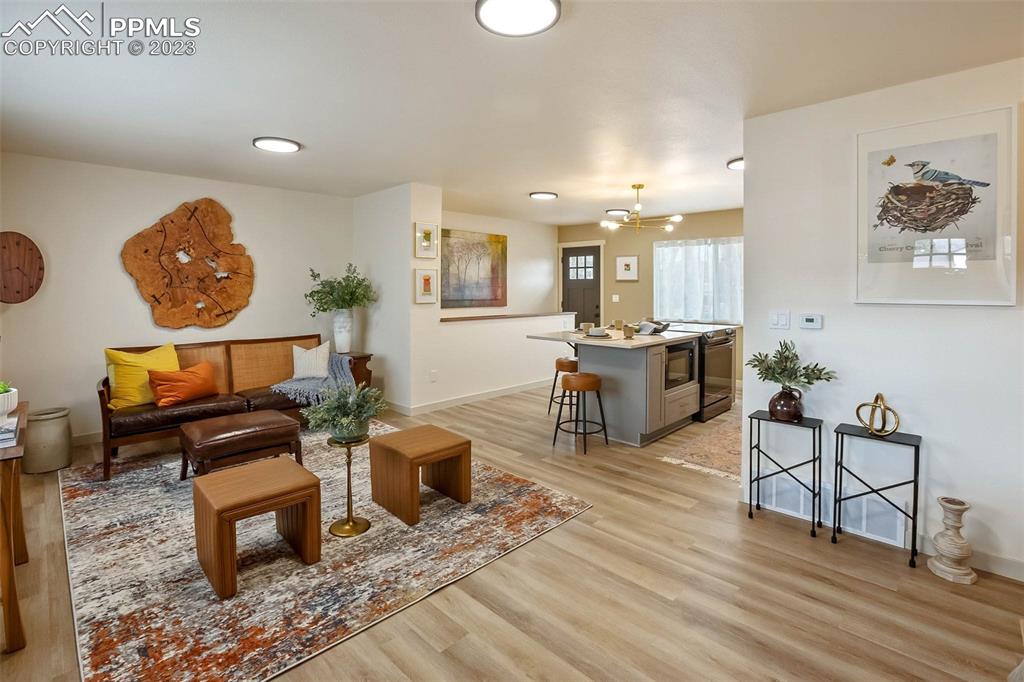 2415 Monterey Road Colorado Springs, CO 80910 - Photo 8 of 36 a living room with furniture and a wooden floor