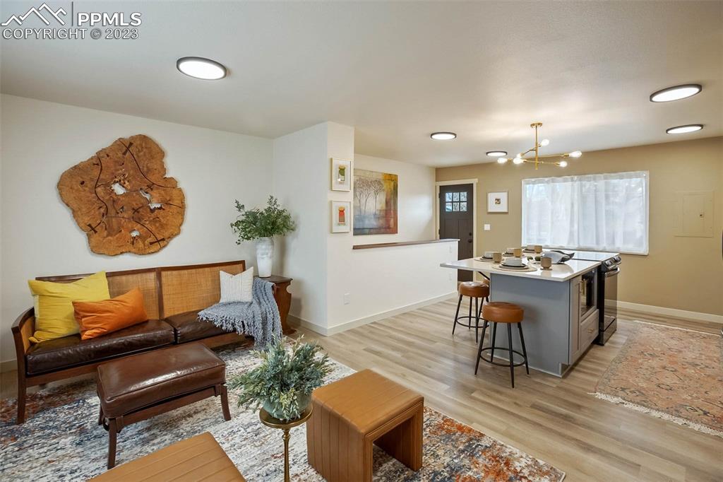 2415 Monterey Road Colorado Springs, CO 80910 - Photo 9 of 36 a living room with furniture and a wooden floor