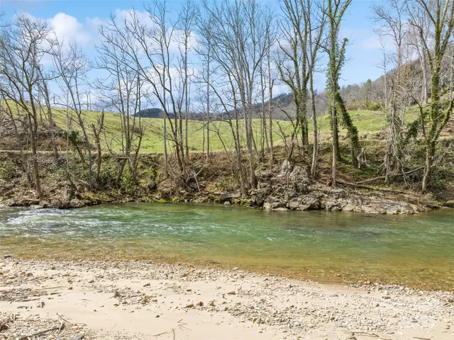 a view of a yard with wooden fence