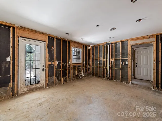 a view of an empty room with staircase