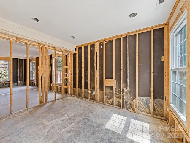 an empty room with windows and a walk in closet