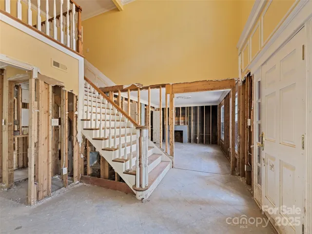 a view of an empty room with a fireplace and a window