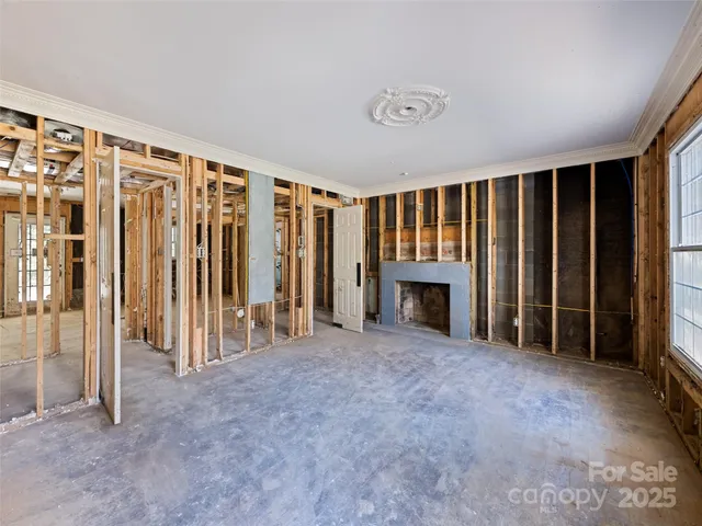 an empty room with furniture and a fireplace