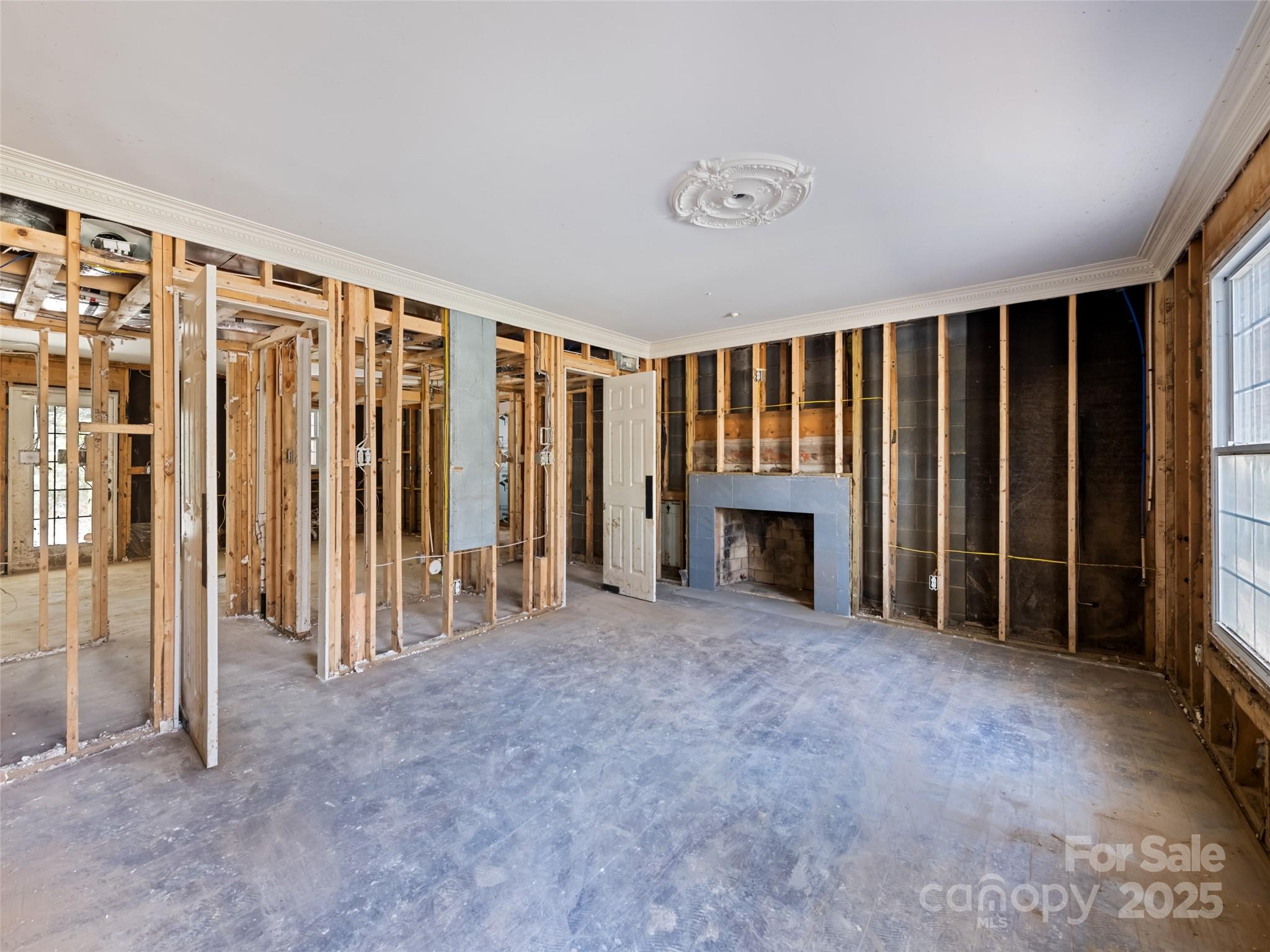 21 Riverbend Street Canton, NC 28716 - Photo 33 of 47 a view of an empty room with a fireplace and a window