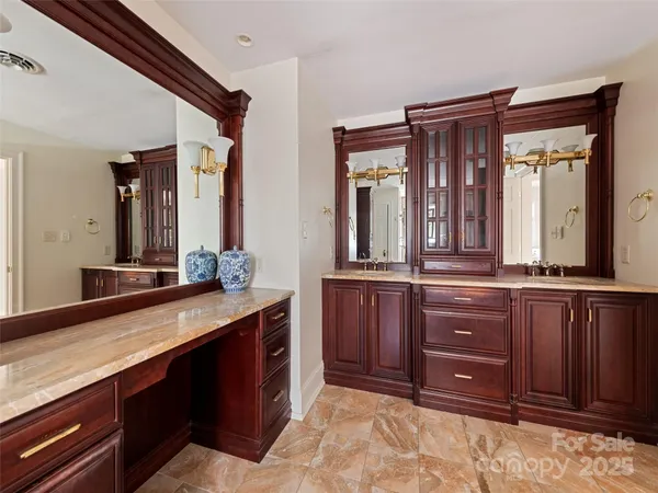 a spacious bathroom with a tub sink and mirror
