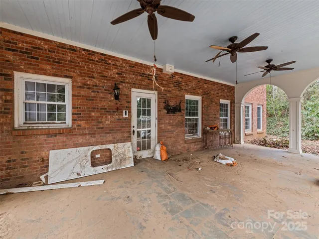 a view of a livingroom with a ceiling fan and window