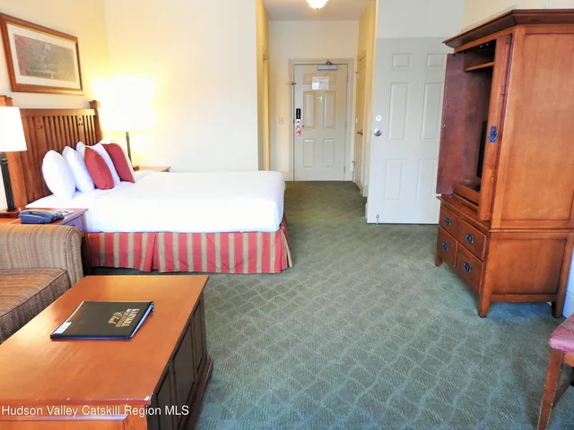 a bedroom with a bed and dresser