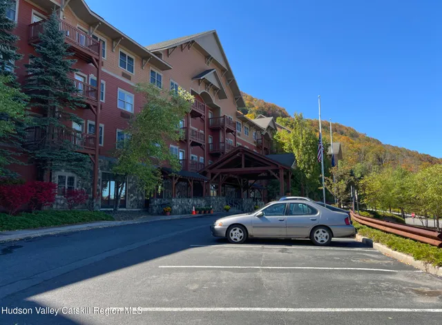 a view of a car parked on the side of a street