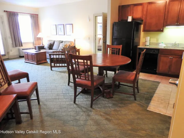 a dining room with furniture and window