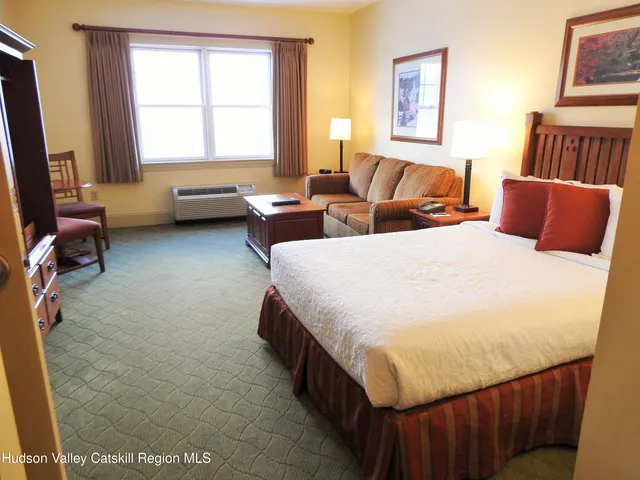 a bedroom with double bed and a window