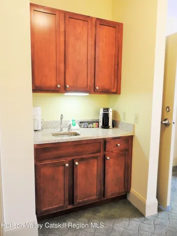 a room with a sink cabinets and utility room