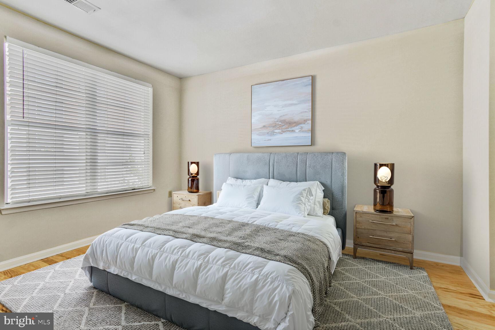 1201 East-West Highway, Unit 331 Silver Spring, MD 20910 - Photo 14 of 34 a bedroom with a bed and a window