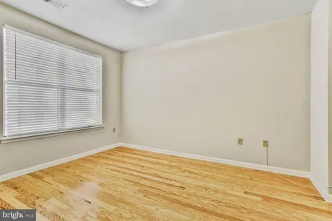 a view of a room with wooden floor and a bathroom
