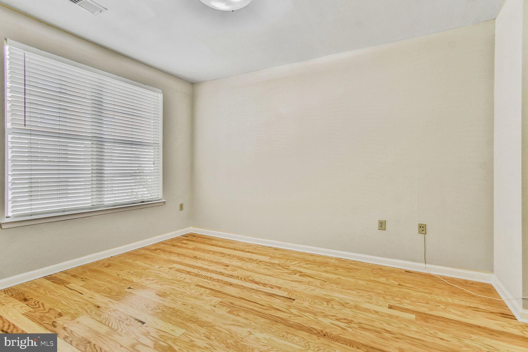 1201 East-West Highway, Unit 331 Silver Spring, MD 20910 - Photo 17 of 34 a view of empty room with wooden floor