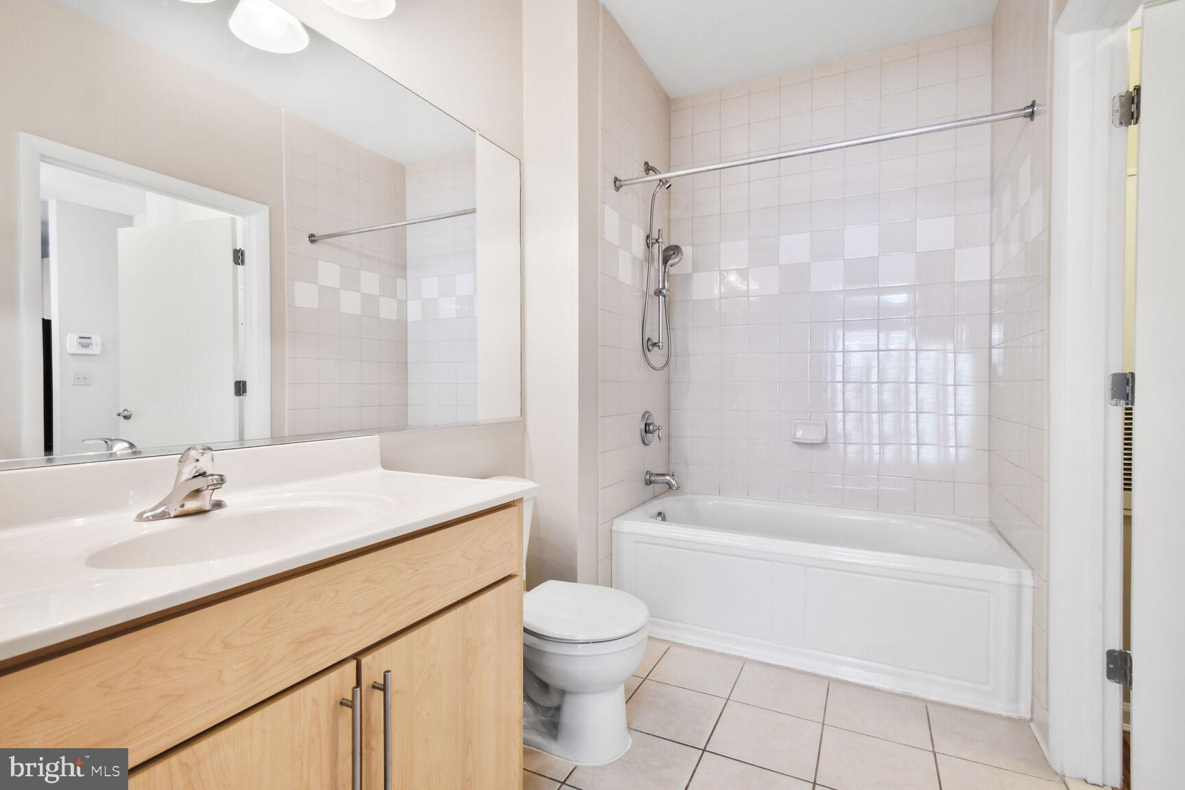 1201 East-West Highway, Unit 331 Silver Spring, MD 20910 - Photo 22 of 34 a bathroom with a sink a toilet and shower