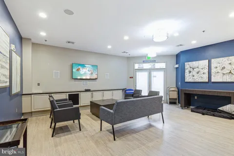 a living room with furniture a large window and a flat screen tv