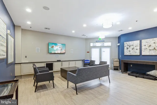 a living room with furniture a large window and a flat screen tv