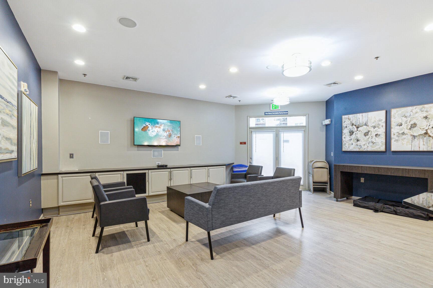 1201 East-West Highway, Unit 331 Silver Spring, MD 20910 - Photo 24 of 34 a living room with furniture and a flat screen tv