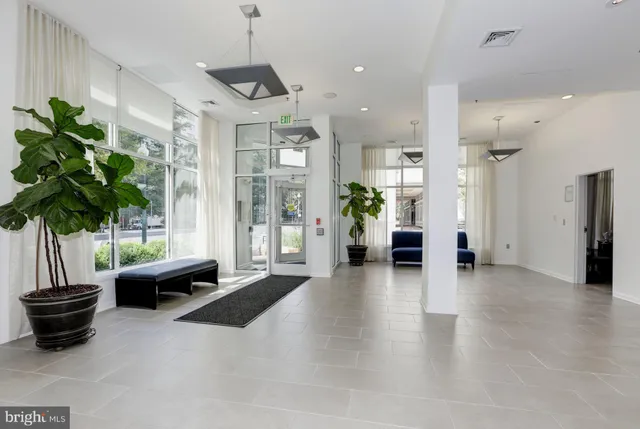 a living room with furniture potted plant and a chandelier