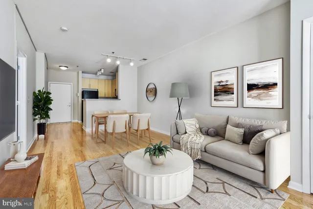 a living room with furniture and a wooden floor
