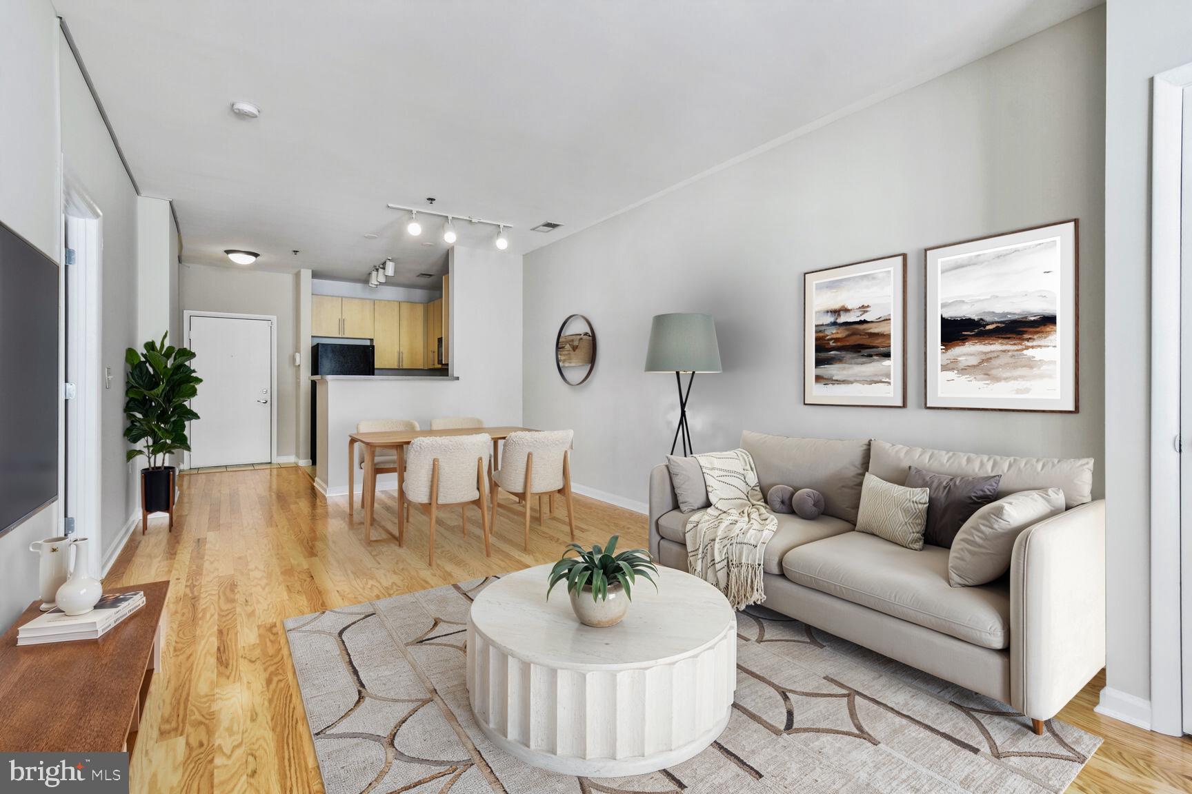 1201 East-West Highway, Unit 331 Silver Spring, MD 20910 - Photo 4 of 34 a living room with furniture and a wooden floor