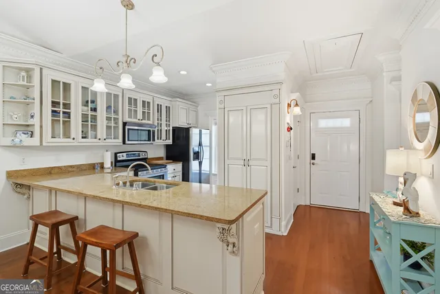 a kitchen with stainless steel appliances granite countertop a refrigerator stove and sink