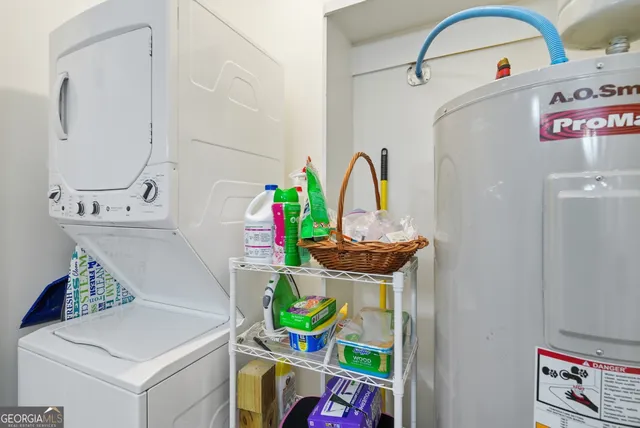 a kitchen with stainless steel appliances granite countertop a sink dishwasher and white cabinets with wooden floor