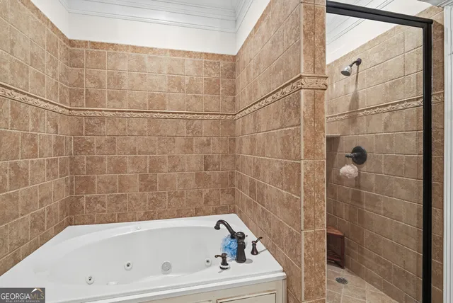 a bedroom with a bed a window and a chandelier