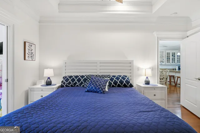 a bedroom with two beds and a chandelier