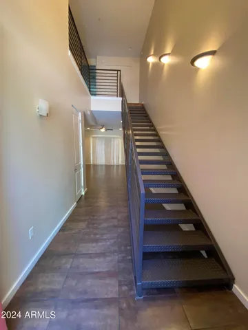 a view of entryway and hall with wooden floor
