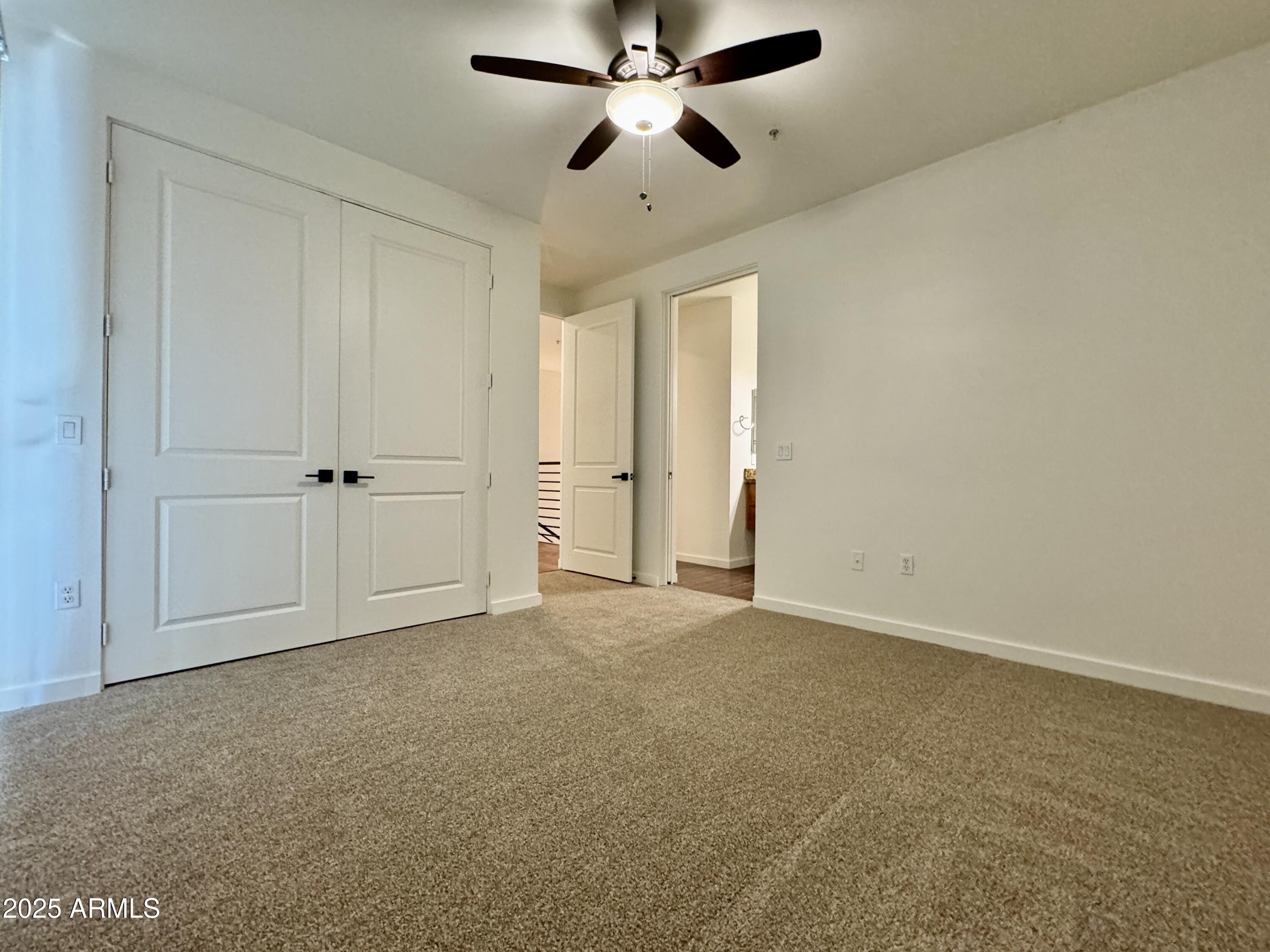 4230 North 21st Street, Unit 12 Phoenix, AZ 85016 - Photo 12 of 17 an empty room with chandelier fan