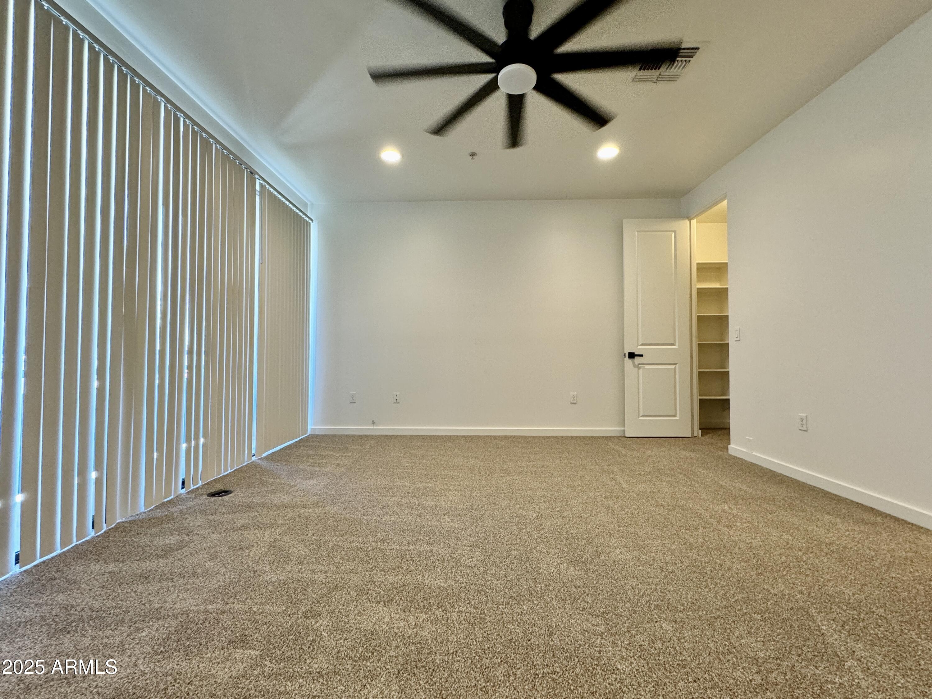 4230 North 21st Street, Unit 12 Phoenix, AZ 85016 - Photo 14 of 17 an empty room with windows and fan