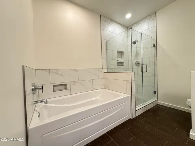 a bathroom with a bathtub and a shower