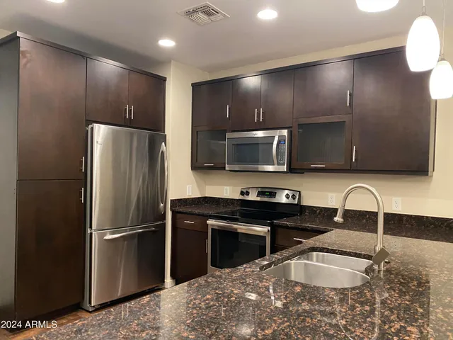 a kitchen with a refrigerator sink and microwave