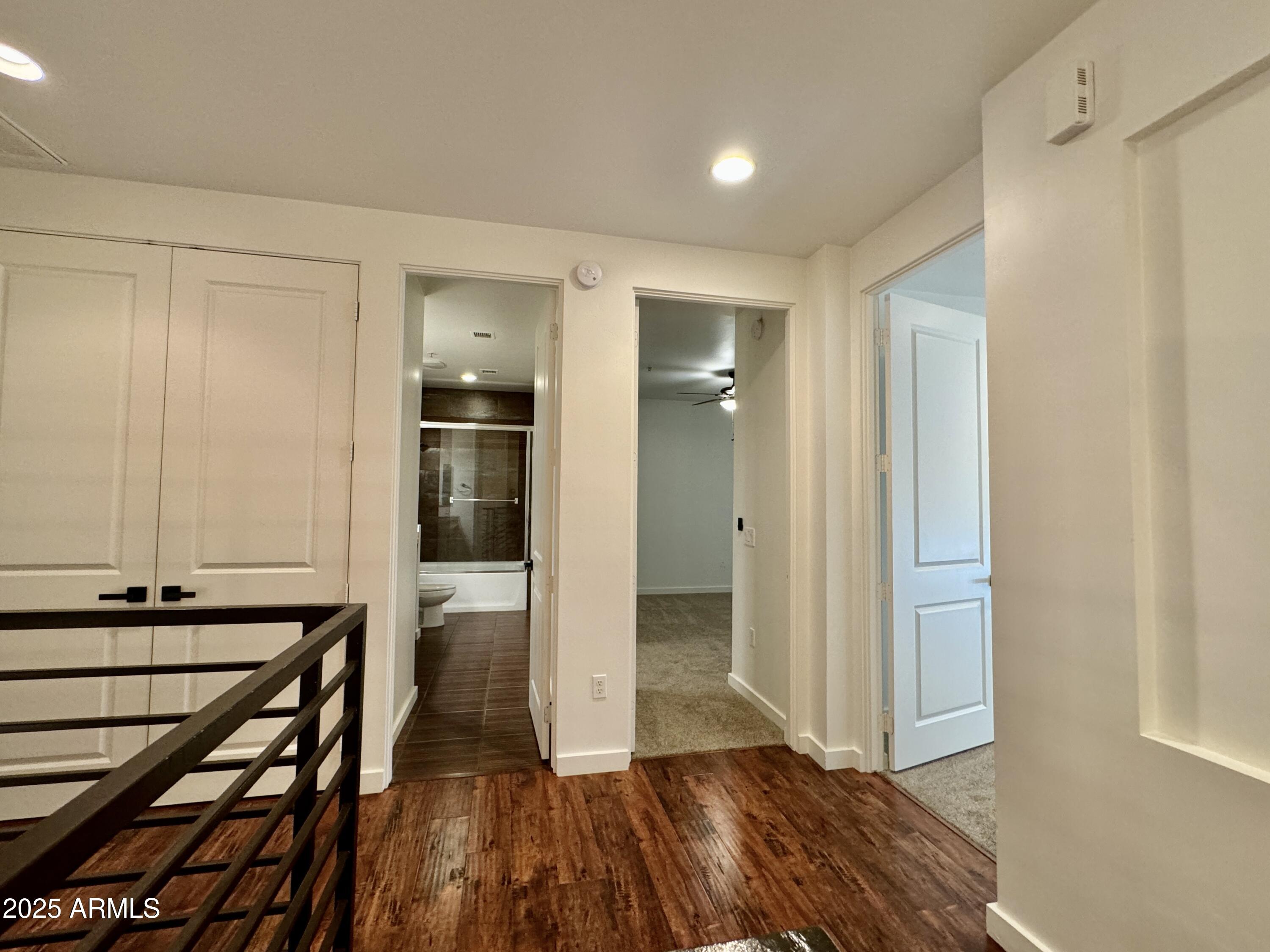 4230 North 21st Street, Unit 12 Phoenix, AZ 85016 - Photo 7 of 17 a view of a hallway with wooden floor and closet