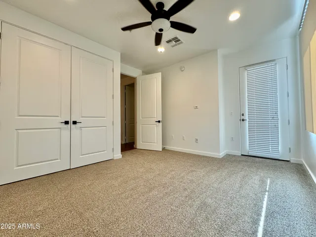 an empty room with closet area