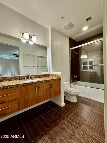 a bathroom with a sink mirror vanity and a toilet