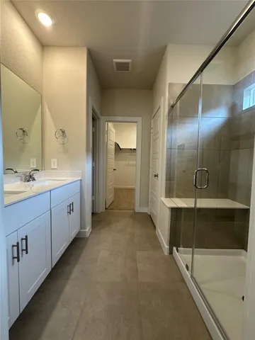 an empty room with windows and bathroom