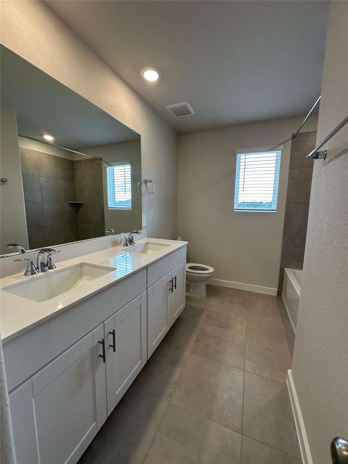 1908 Velvet Oak Lane Conroe, TX 77304 - Photo 16 of 16 a bathroom with a double vanity sink a mirror and a bathtub