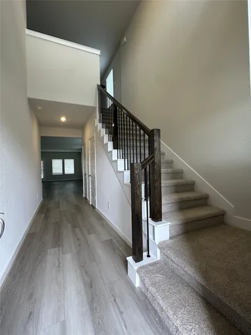 a view of entryway and hall with wooden floor