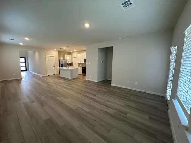 a view of kitchen with cabinets microwave and stove