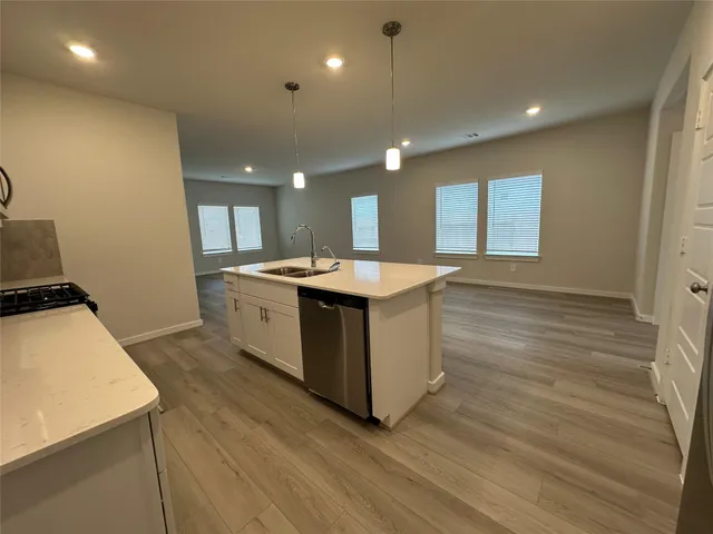a bathroom with a granite countertop sink and washing machine
