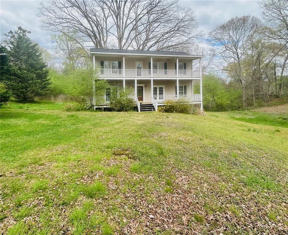 404 Main Street Talmo, GA 30575 - Photo 1 of 1 a view of a house with a garden