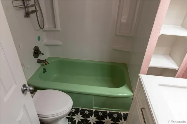 a bathroom with a sink toilet and mirror