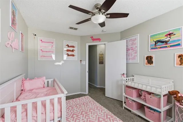 a bedroom with furniture a book shelf and a window